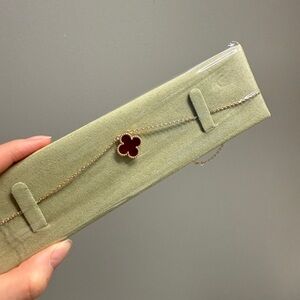 Elegant Gold Bracelet with Red Clover Charm